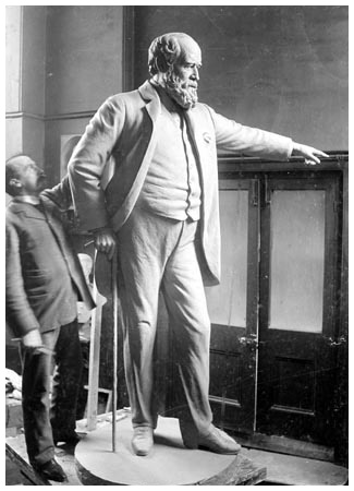 Sculptor Walter Merritt working on his statue of Archibald Hood, circa 1905. Bronze statue erected in front of the Llwynypia Miner's Library and Institute in 1906, Workmen of Hood's collieries contributed £600 towards its erection.