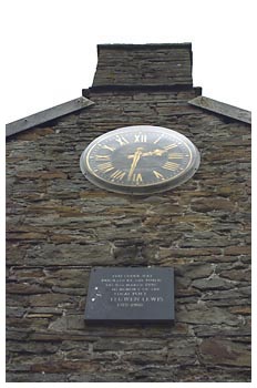 The clock and plaque on the old blacksmiths